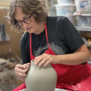 Judi Harwood throwing vase on potters wheel